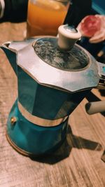 Close-up of hand holding tea cup on table