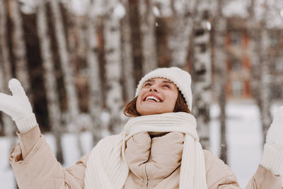 Portrait of smiling woman standing in forest