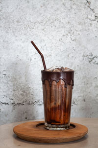 Close-up of coffee on table against wall