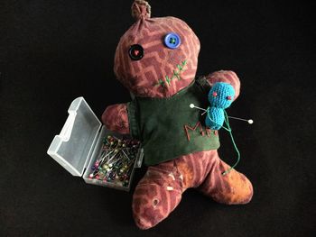 Close-up of toy with colorful pins on black background