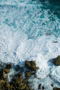 Waves splashing on rocks at shore