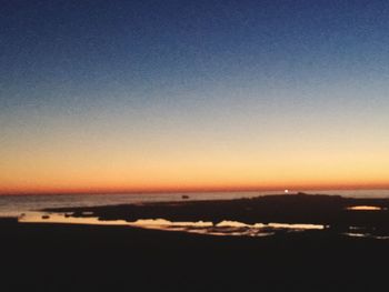 Scenic view of sea against clear sky during sunset