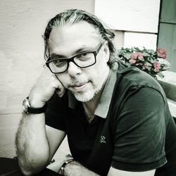 Portrait of young woman standing against wall