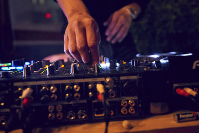 Cropped image of dj mixing sound at nightclub