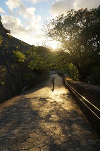 Man walking on mountain against sky