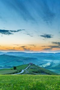 Scenic view of field against sky during sunset