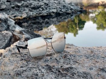 Close-up of sunglasses on rock