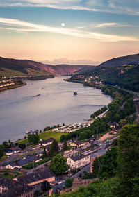 High angle view of city by sea against sky