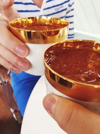 Cropped image of people toasting drinks