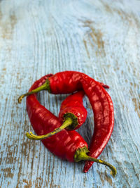 Close-up of red chili peppers on wooden table