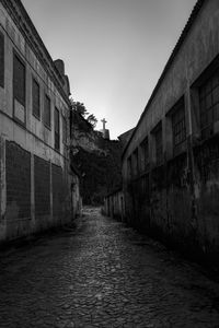 Street amidst buildings against clear sky