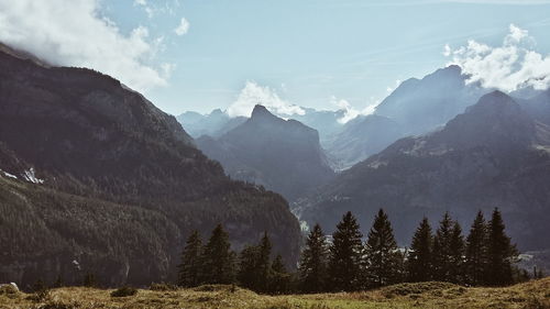 Scenic view of rocky mountains against sky on sunny day