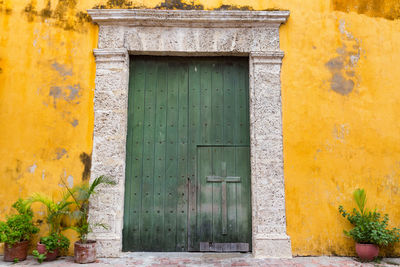 Closed door of yellow house