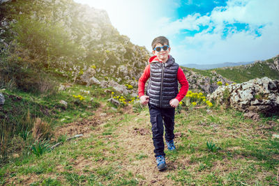 Full length of woman standing on mountain