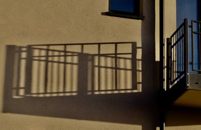 Shadow of railing on wall