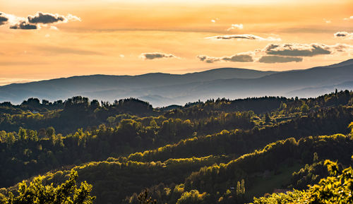 Scenic view of mountains against sky at sunset