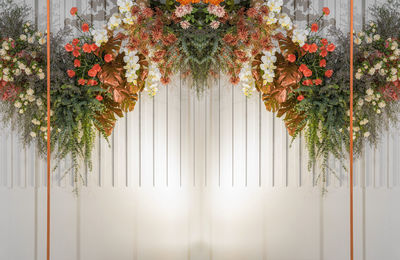 Flowers hanging against white wall