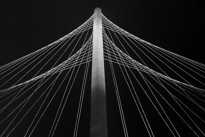 Low angle view of suspension bridge against sky at night