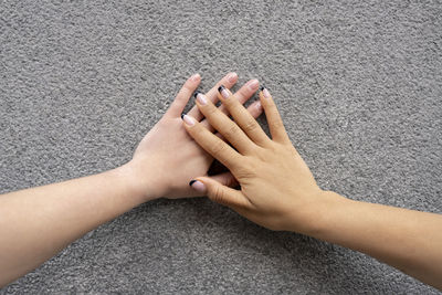 High angle view of woman touching hand