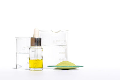 Close-up of yellow glass over white background