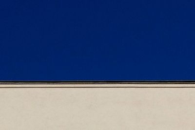 Low angle view of building against clear blue sky