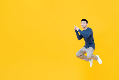 Portrait of a young man jumping