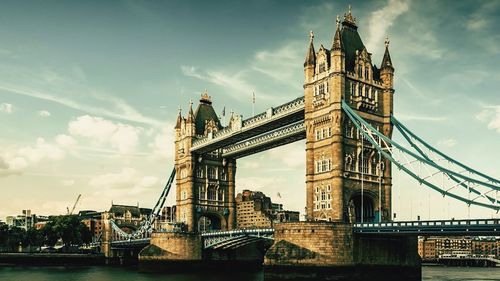 View of bridge over river against cloudy sky