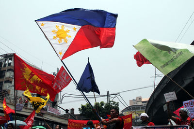 Low angle view of flag flags against sky