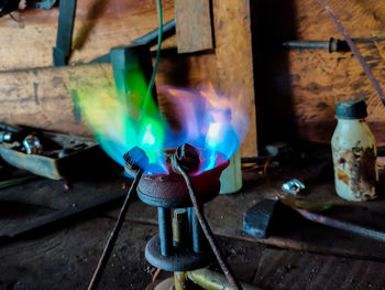 High angle view of burning candles on metal