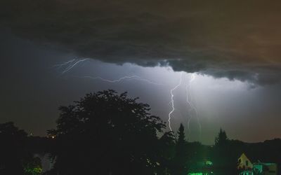 Low angle view of lightning in sky at night