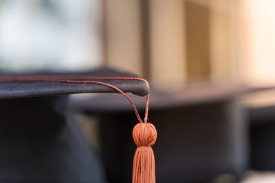 Close-up of bell hanging on rope