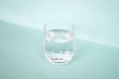 Close-up of wineglass against blue background