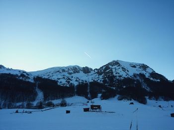 Snow covered mountains against clear sky