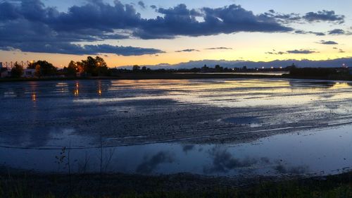 Scenic view of lake at sunset