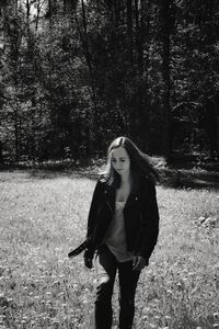 Full length of young woman standing on field