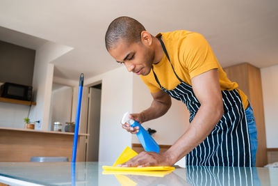 Young man looking at camera at home