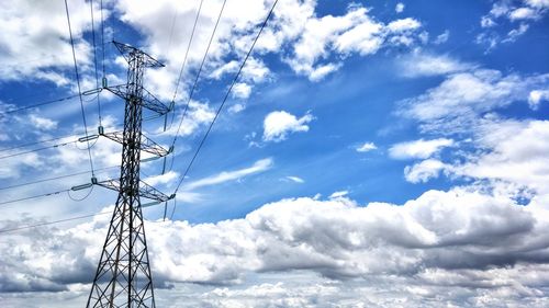 Low angle view of electricity pylon against sky