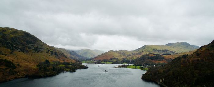 Scenic view of lake and mountains against sky