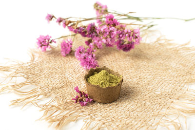 Close-up of pink flowers on sand