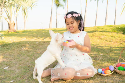 Full length of girl sitting on field