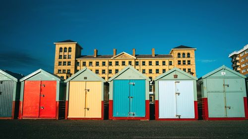 Houses at beach against clear blue sky