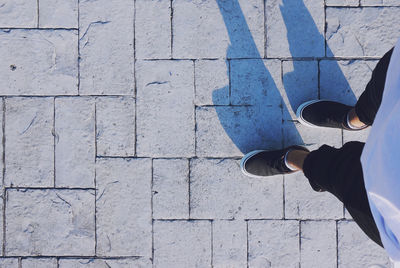 Low section of person walking on footpath