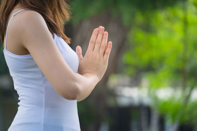 Midsection of woman standing in park