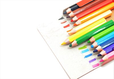 High angle view of multi colored pencils against white background