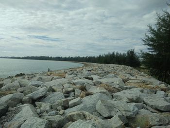 Rocks by sea against sky