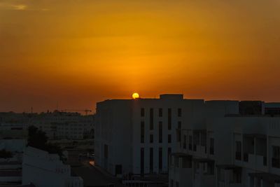 High angle view of buildings against sky during sunset