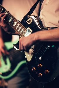 Close-up of man playing guitar