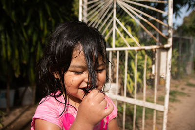Little girl having fun outdoors summer wet hair