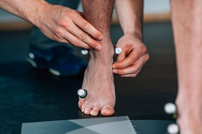 Cropped hands of person with equipment on feet