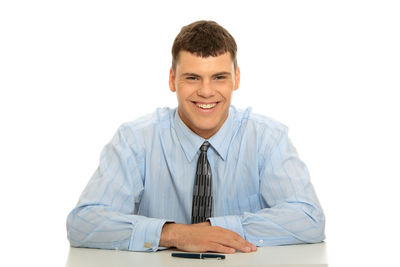 Portrait of smiling mid adult man against white background